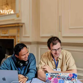 Sage and Thibaud looking at laptops