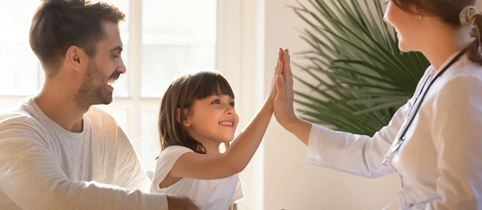 Healthy child girl giving high five to doctor celebrate recovery