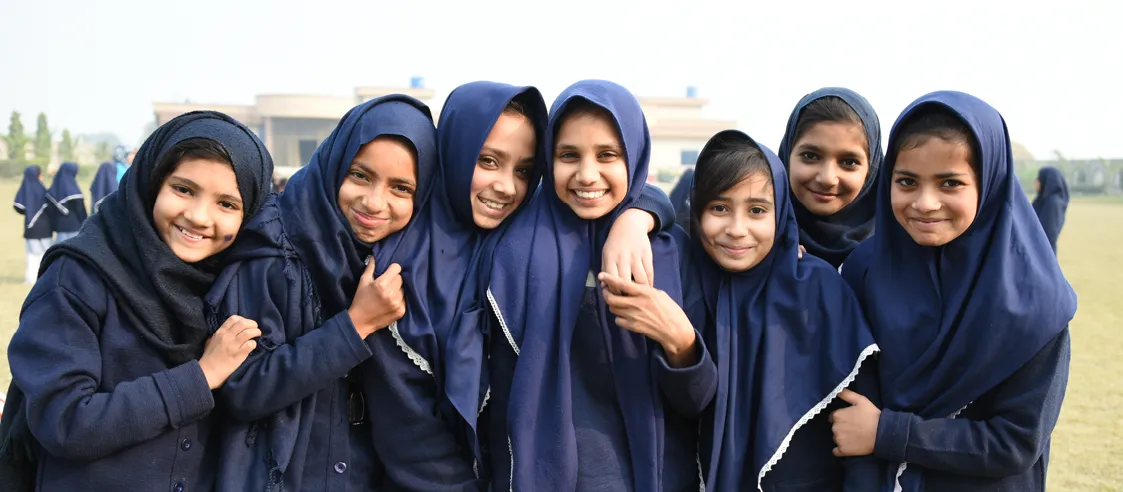 Seven young girls group together for a photo