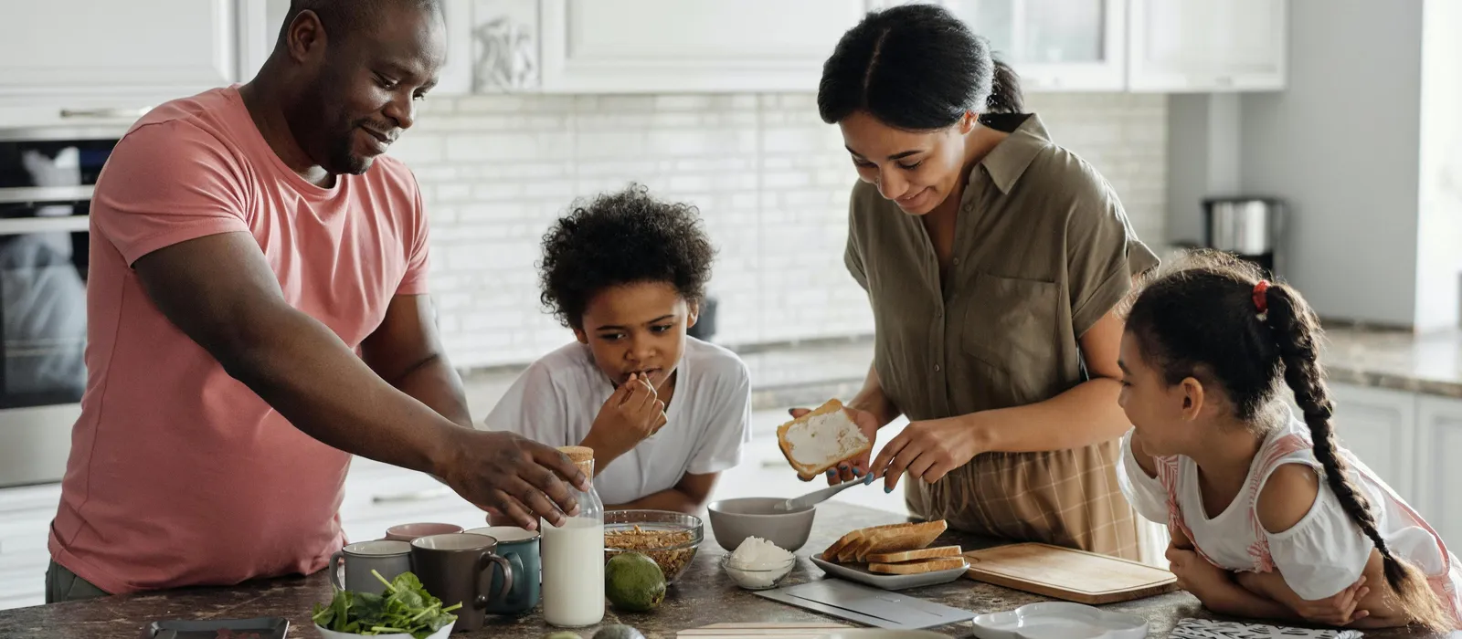 Family making breakfast in kitchen